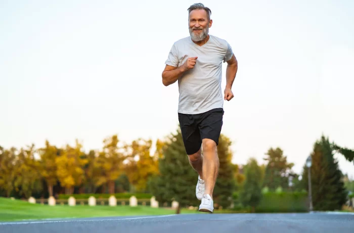 A mature woman stops for a rest during a run