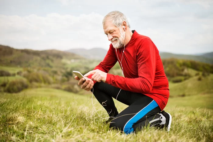 An Ontario man stops to check his phone while out on a run