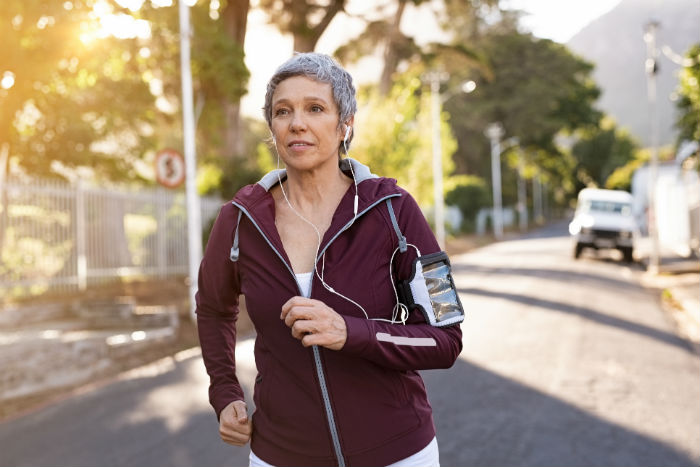 mature female runner A mature woman stops for a rest during a run