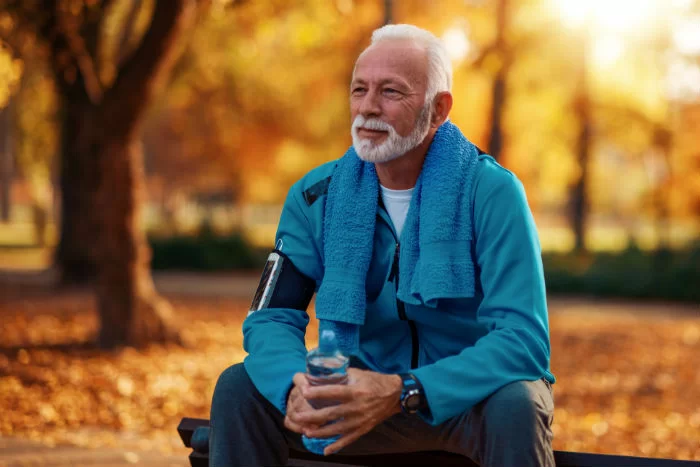 mature female runner A mature woman stops for a rest during a run