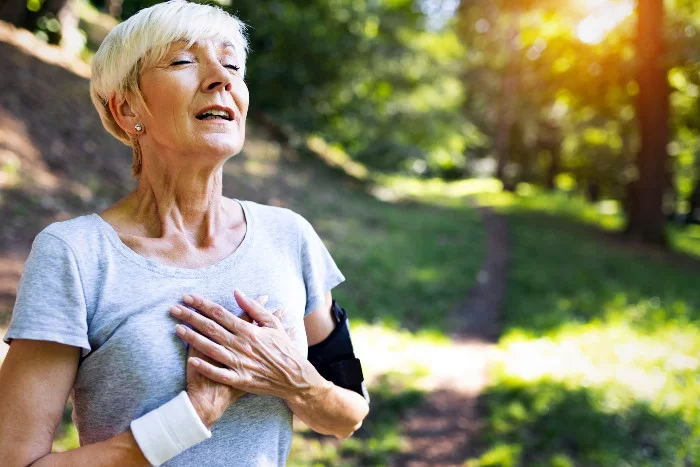 mature female runner A mature woman stops for a rest during a run