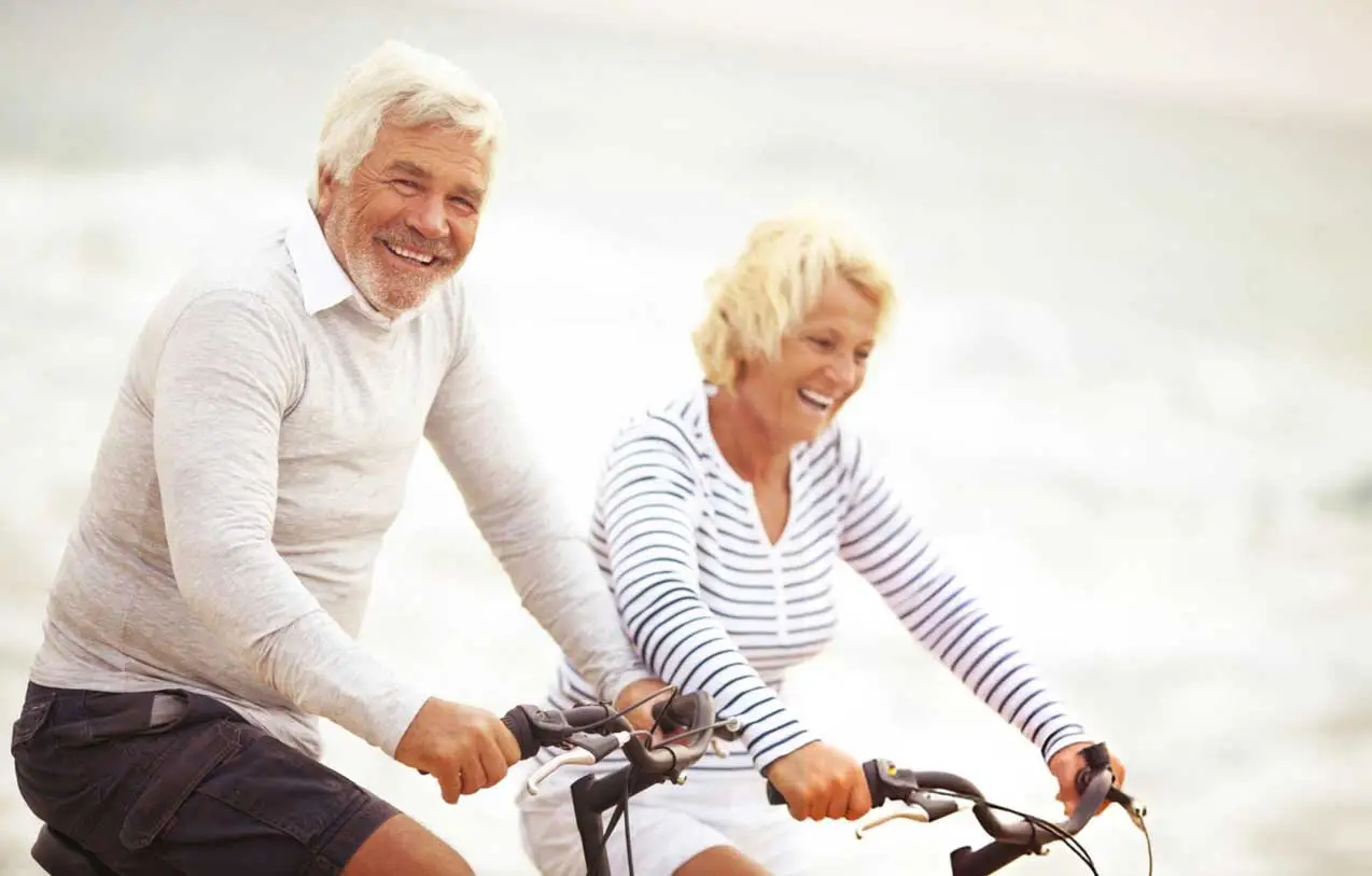 senior-couple-biking-beach-stem-cell-therapy-liberty-lake