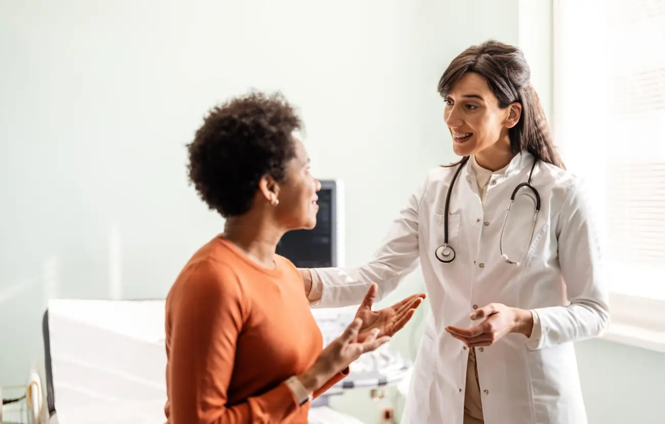 A friendly female doctor with a stethoscope consults with a female patient in a medical office, discussing regenerative medicine and stem cell therapy options in Lebanon, TN.