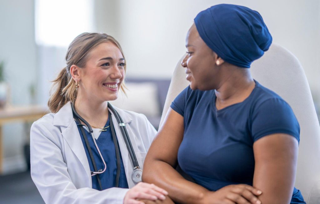 A compassionate doctor discusses non-surgical treatment options with a female patient during a consultation in Westwood, MA.