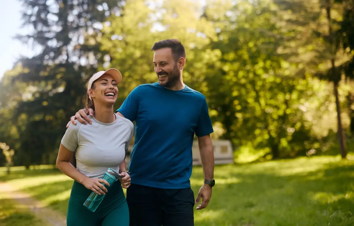 A happy couple enjoys an active, pain-free walk in a park in Annandale, VA, after successful stem cell therapy.