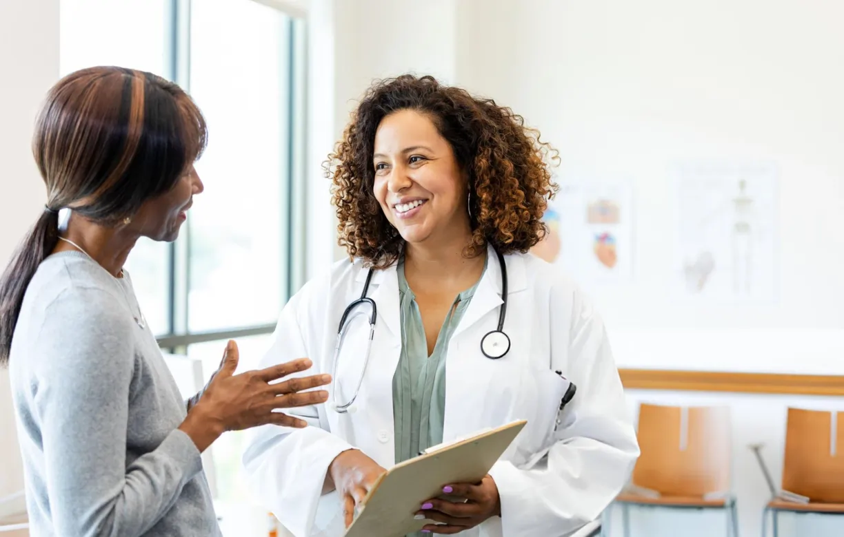 A female patient discusses treatment options with a caring doctor during a stem cell therapy consultation in Annandale, VA.